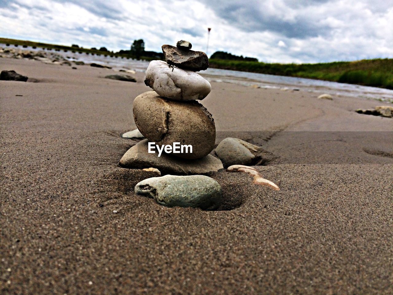 Stone stack on beach against sky