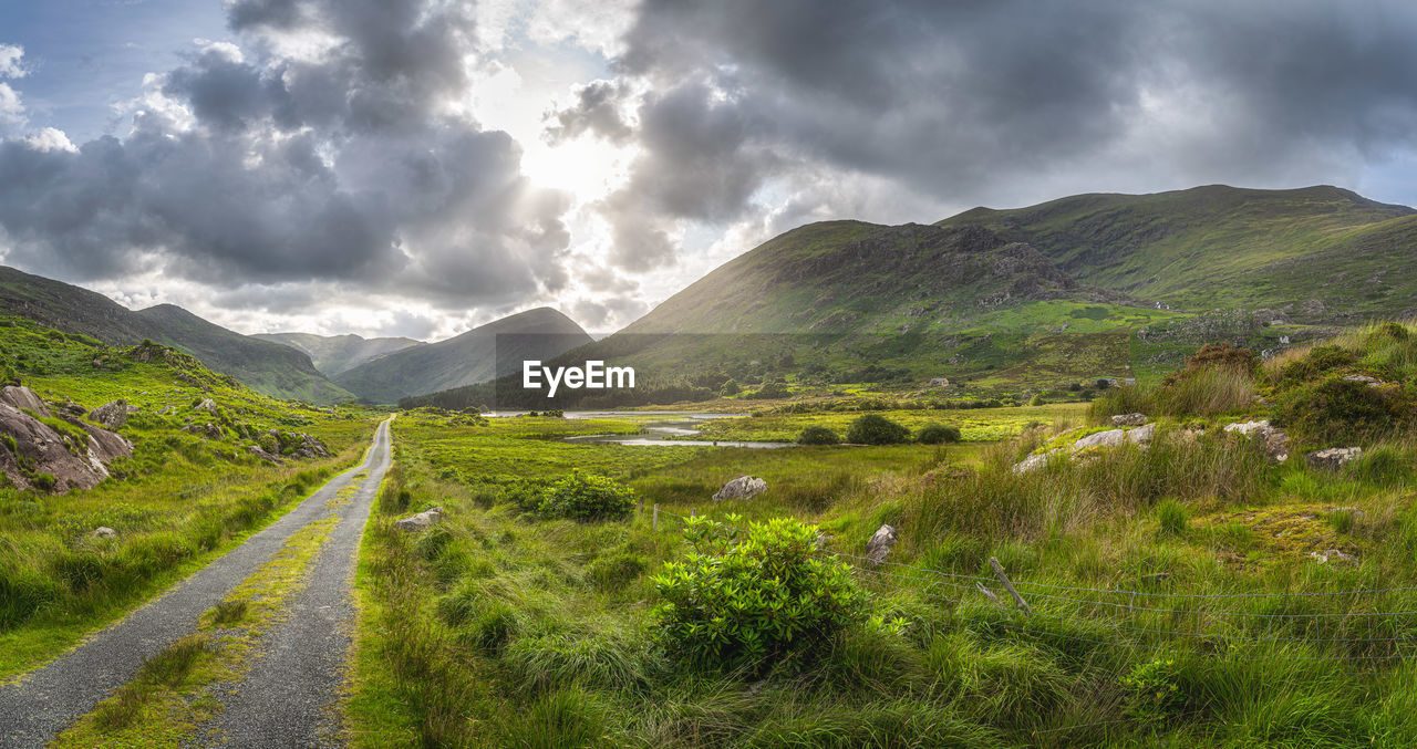 Straight country road leading trough black valley, macgillycuddys reeks mountains, ireland