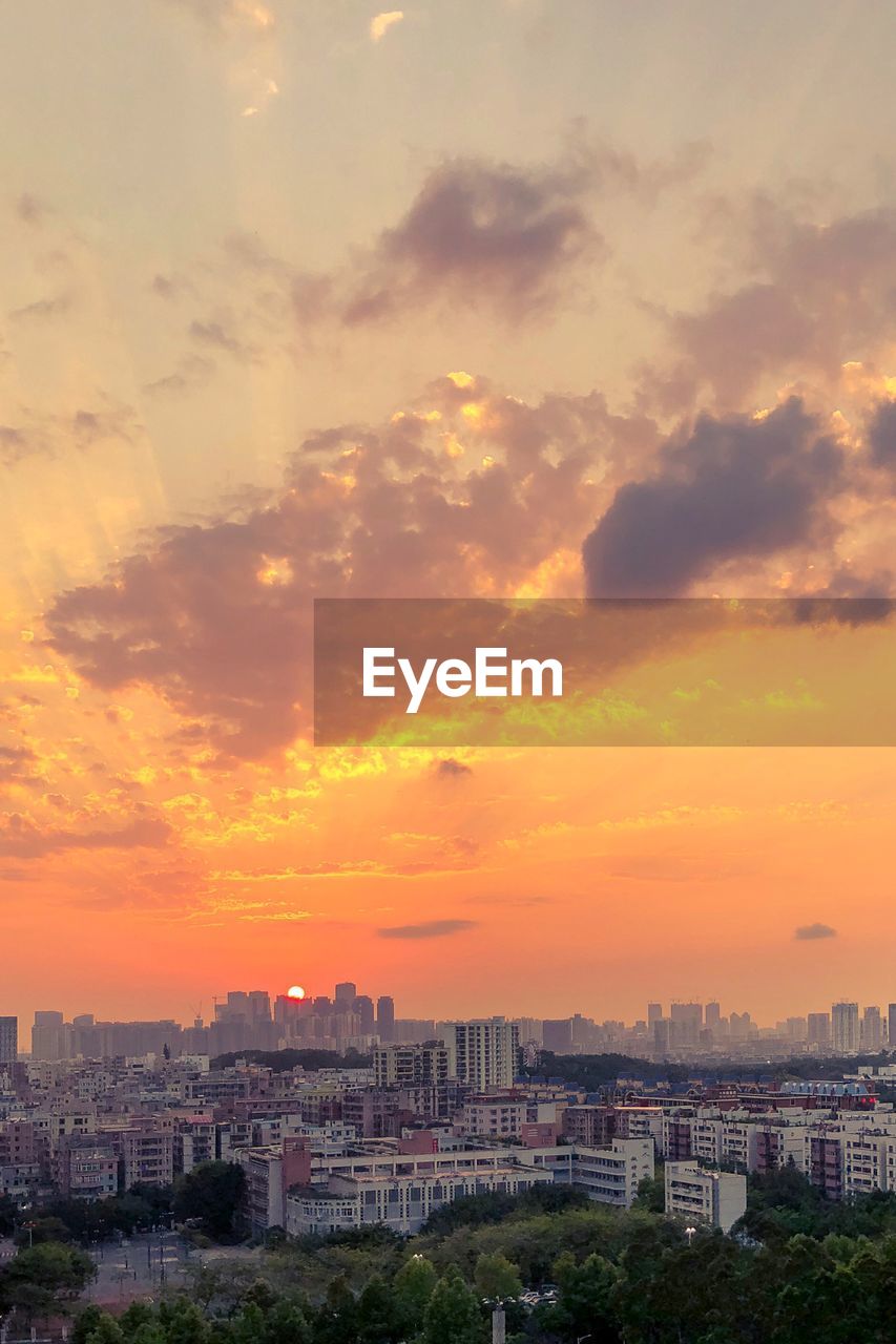 High angle view of buildings against sky during sunset