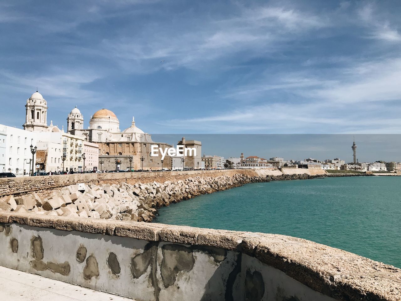 HISTORIC BUILDING BY SEA AGAINST BLUE SKY