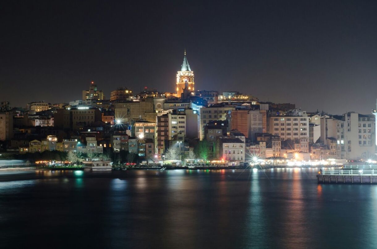 Buildings at the waterfront lit up at night