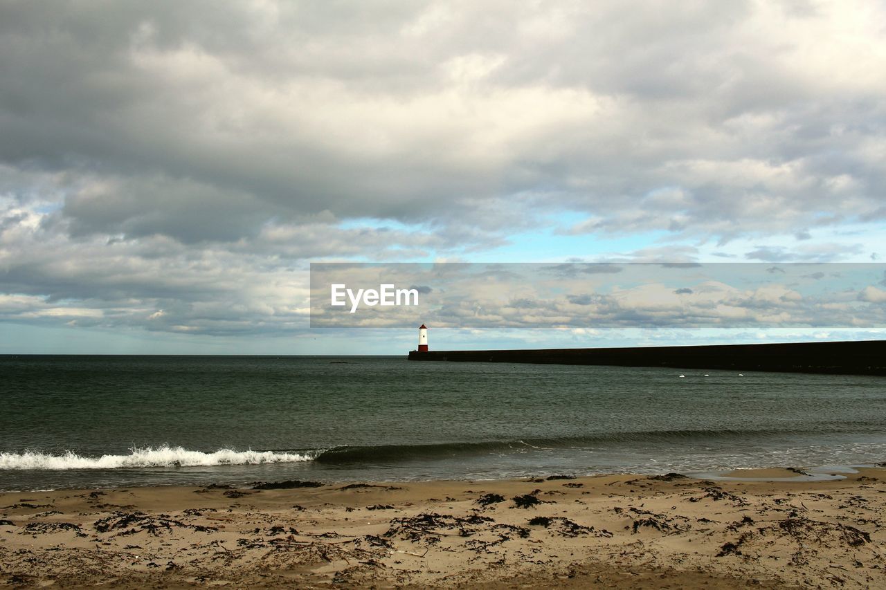 Scenic view of sea against cloudy sky