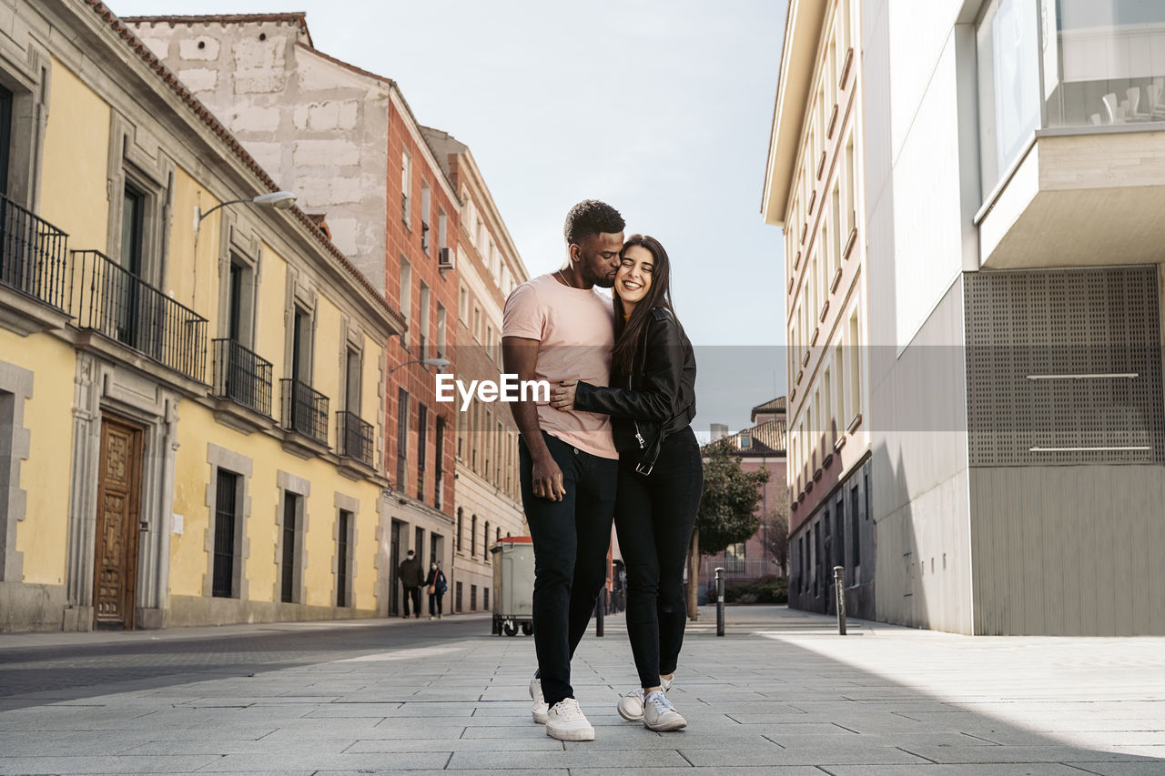 Couple standing on road in city