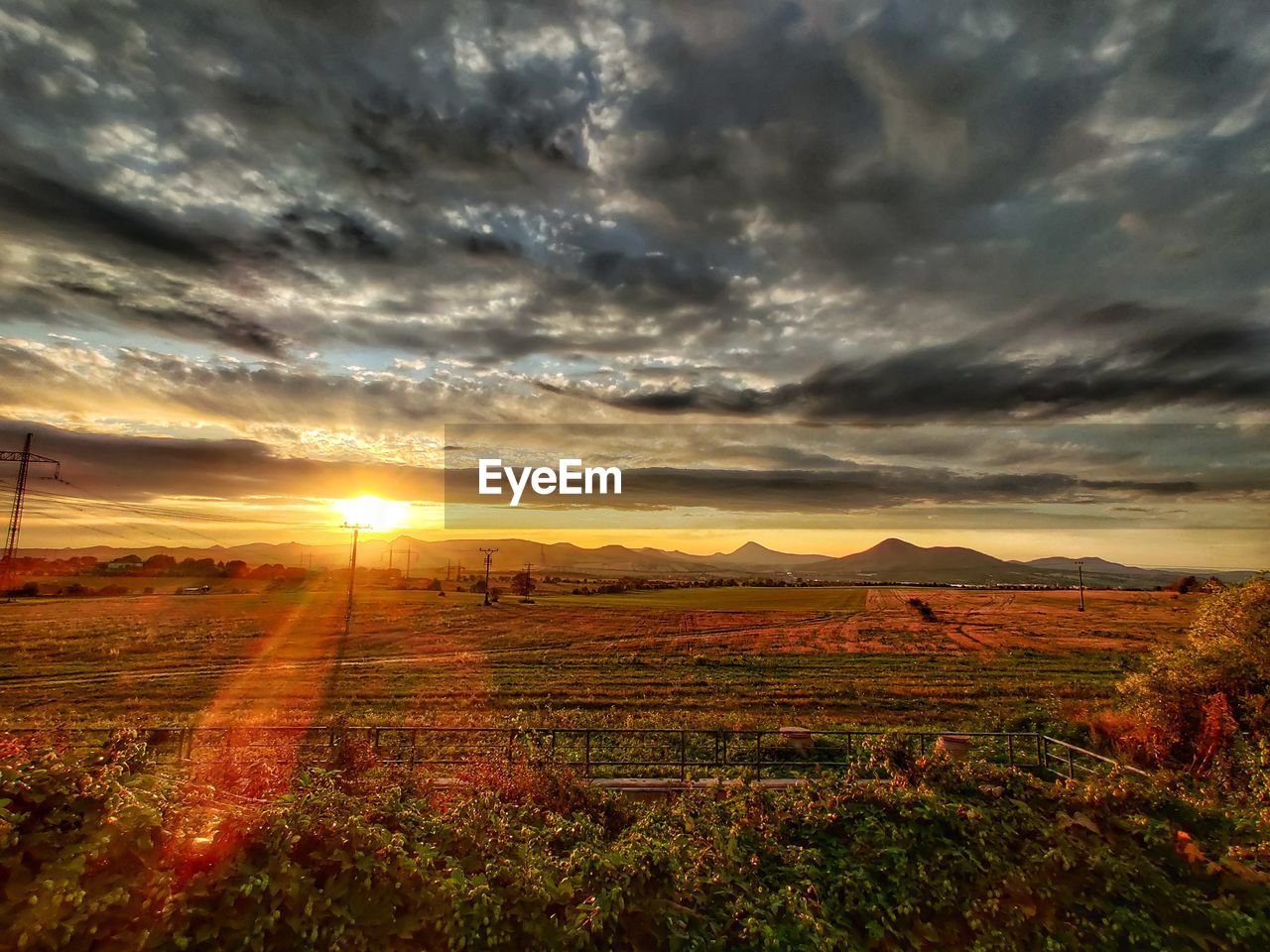 FIELD AGAINST SKY DURING SUNSET