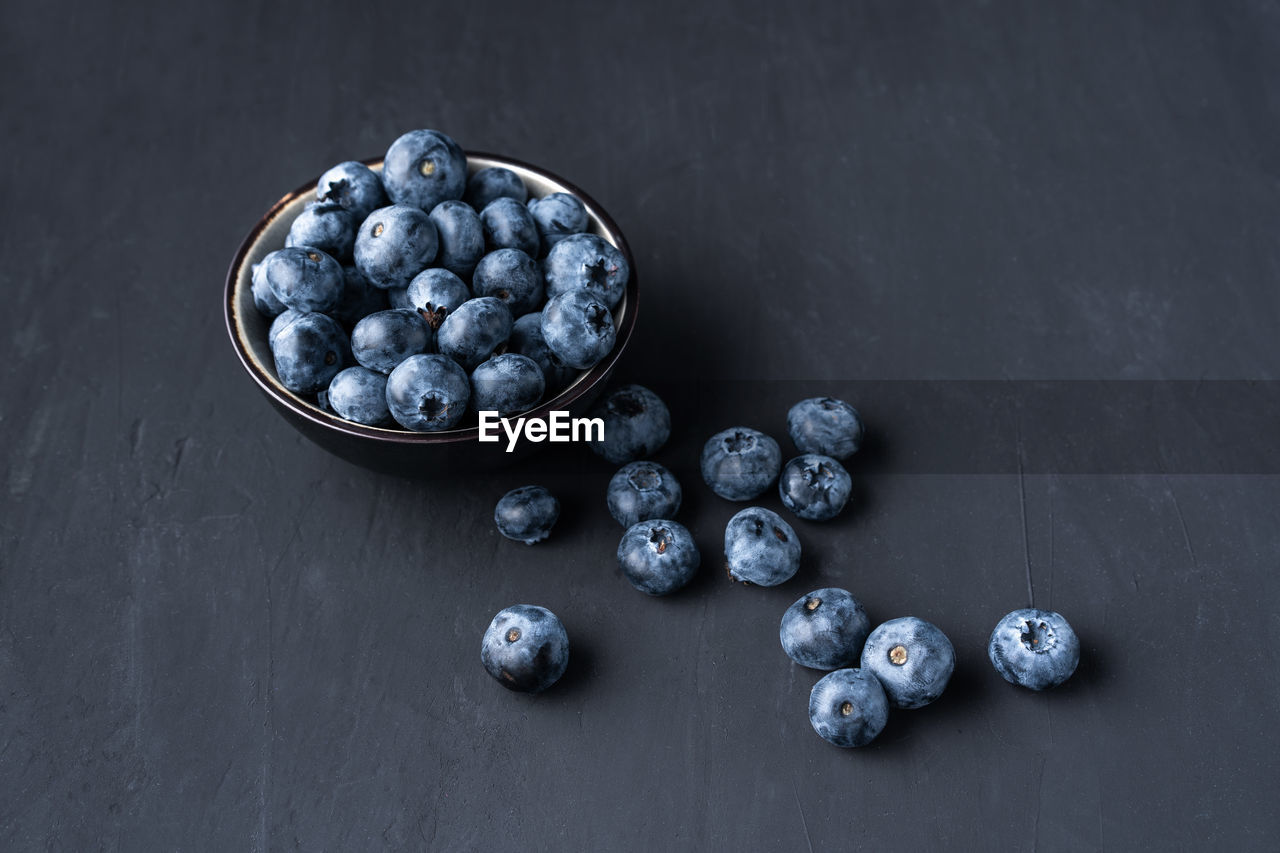 High angle view of blueberries in bowl on table