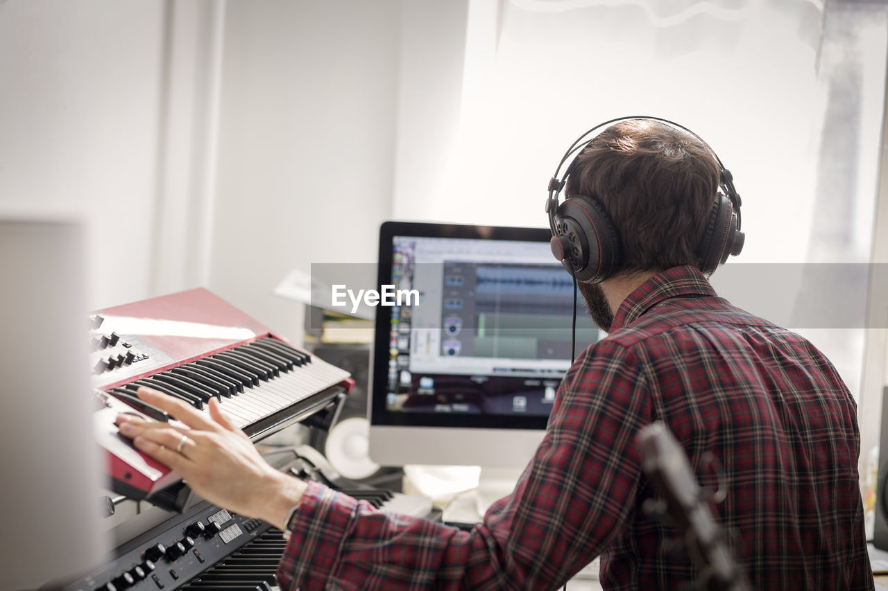 Man practicing piano at home