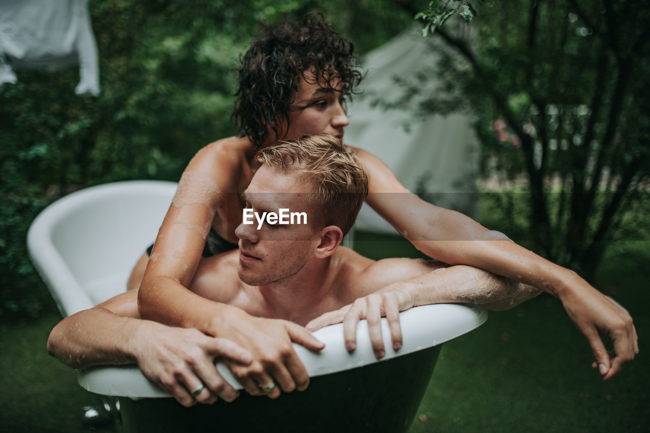 Couple in bathtub outdoors