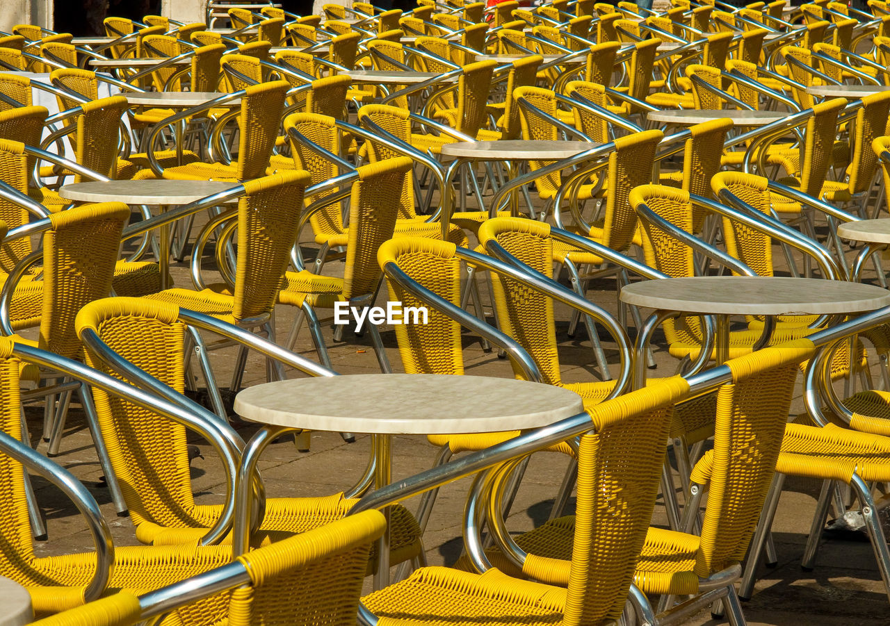 Yellow chairs and table at outdoor cafe