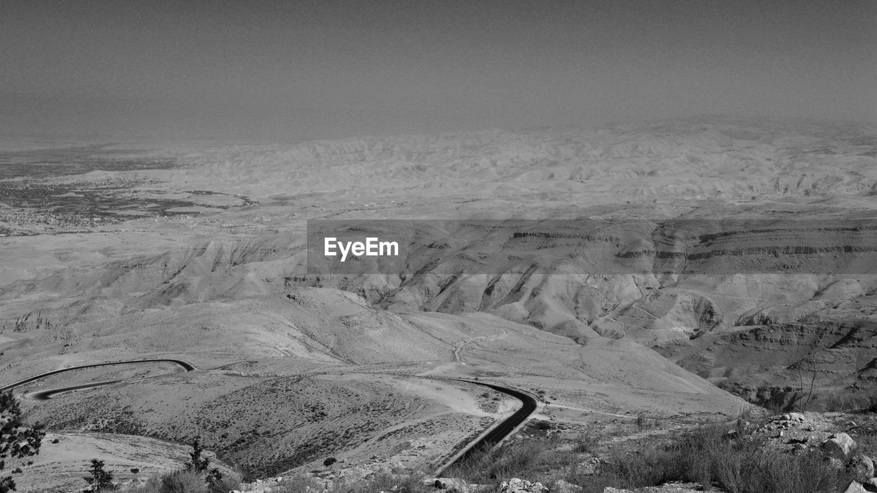 Scenic view of mountains in desert against sky