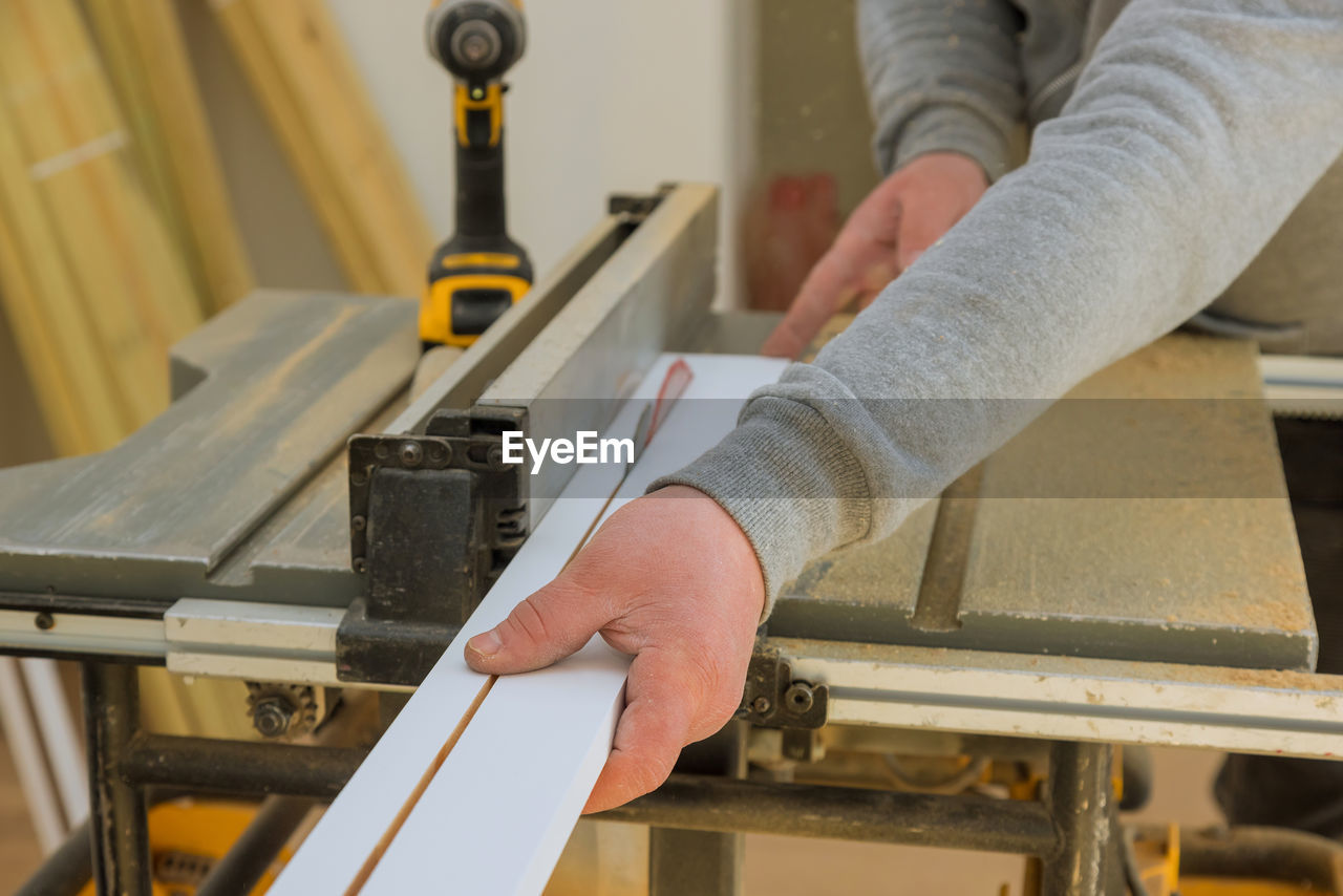 Midsection of carpenter working at workshop