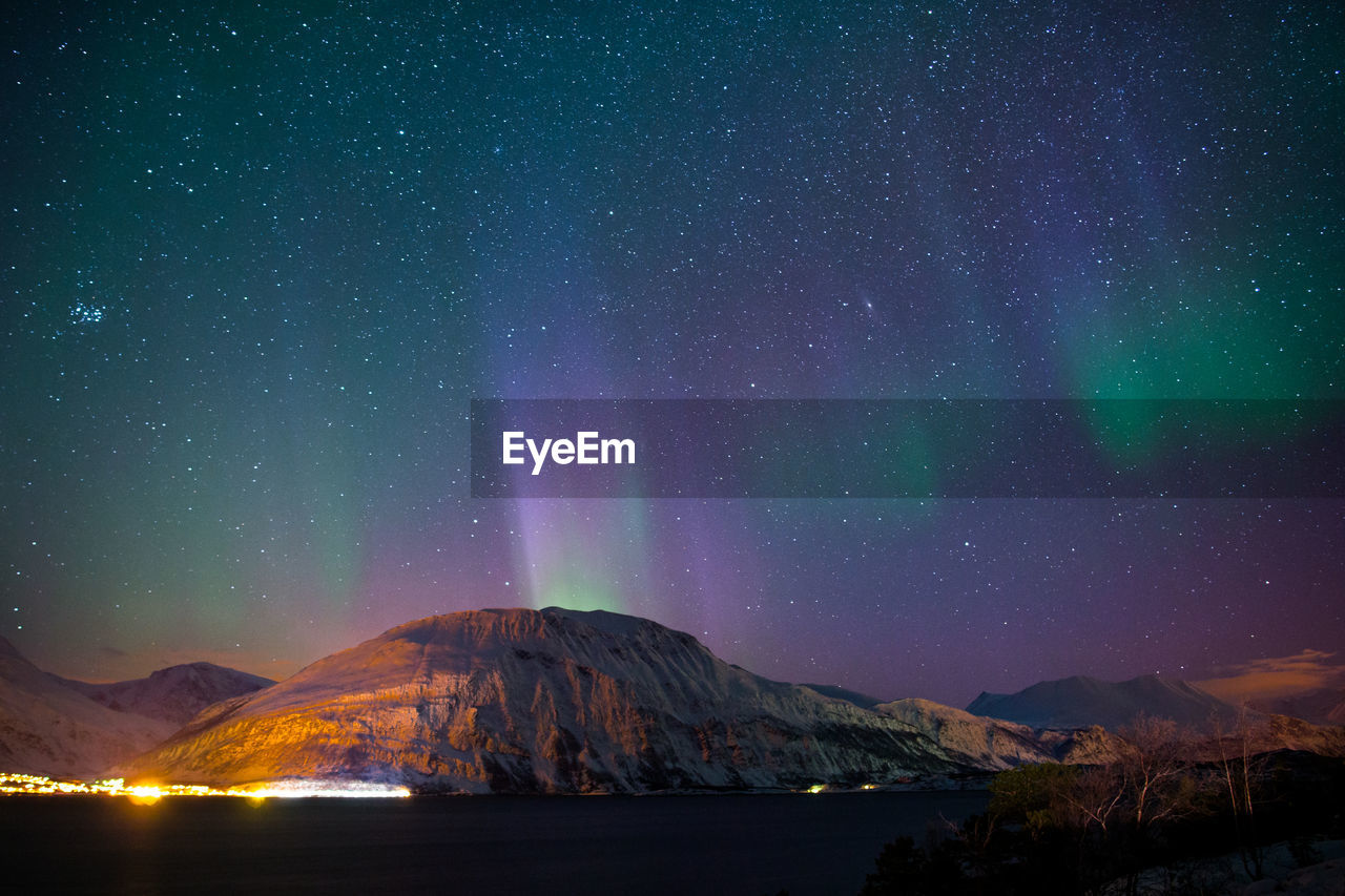 Scenic view of mountains against sky at night
