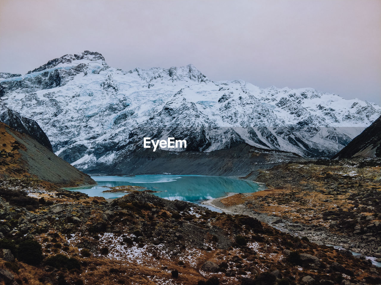 Scenic view of snowcapped mountains against sky with lake