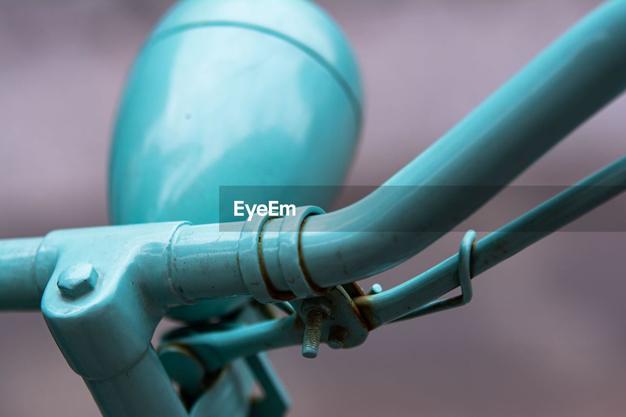 CLOSE-UP OF BICYCLE PARKED ON METAL