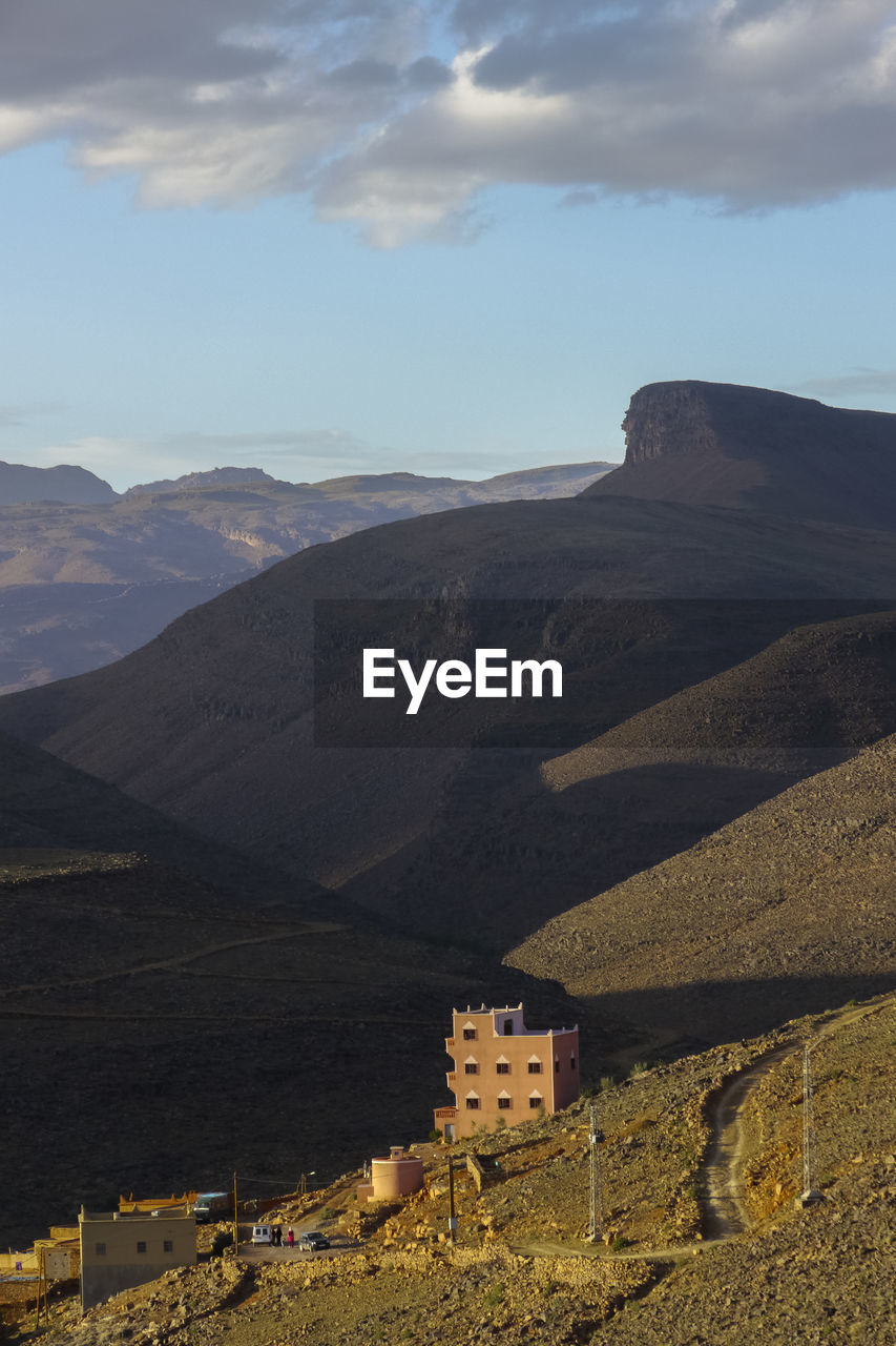 Scenic view of mountains against cloudy sky