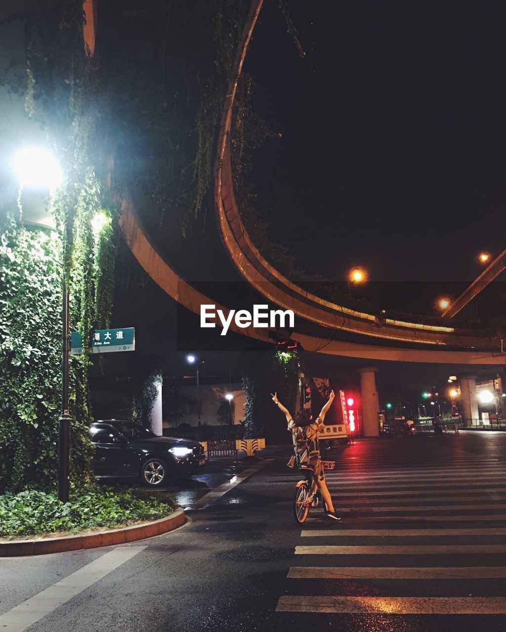 MAN ON ILLUMINATED STREET AT NIGHT