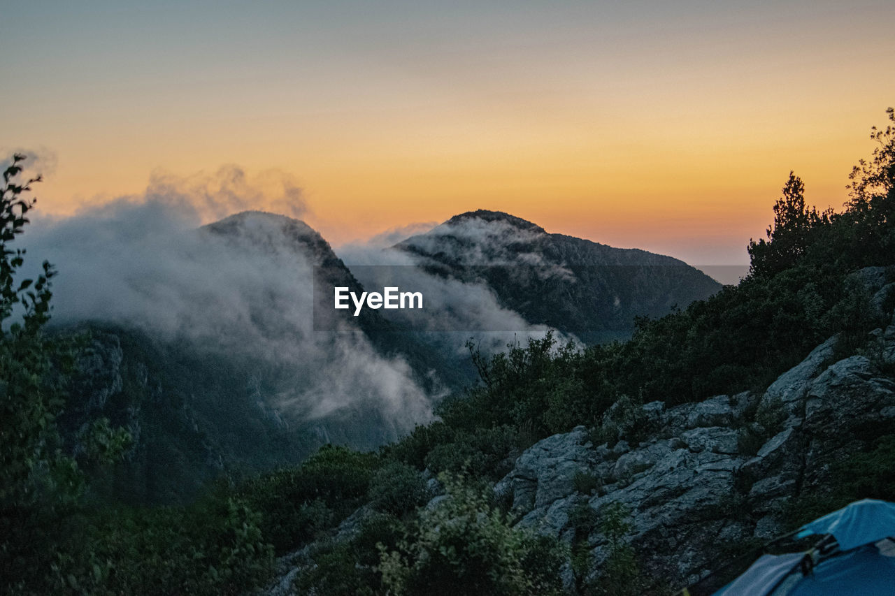 low angle view of mountain against sky during sunset