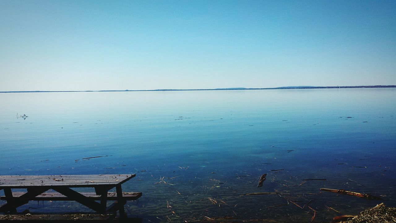 Scenic view of sea against clear blue sky