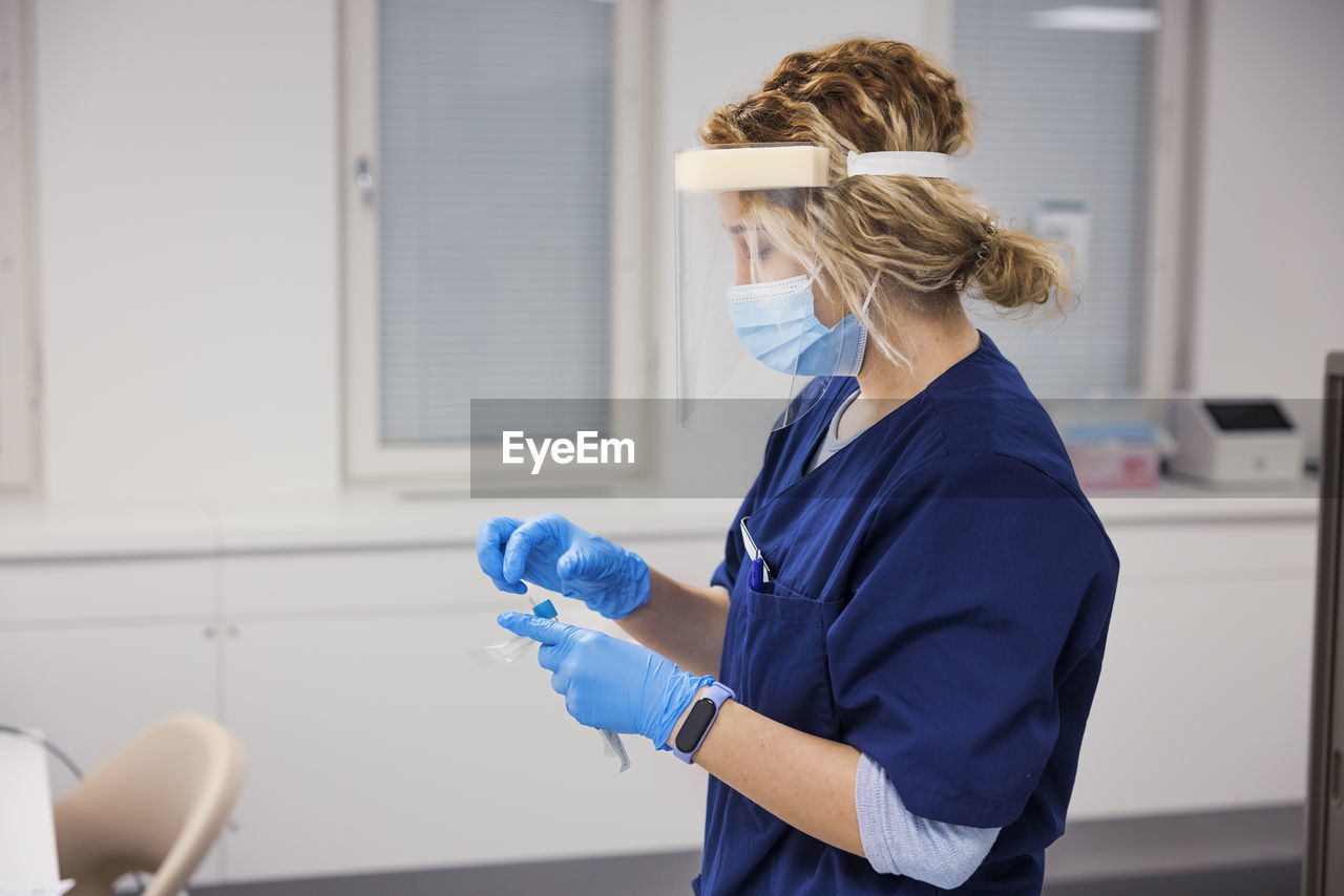 Female doctor preparing covid-19 swab test