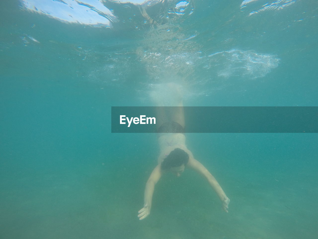 Rear view of man swimming at underwater