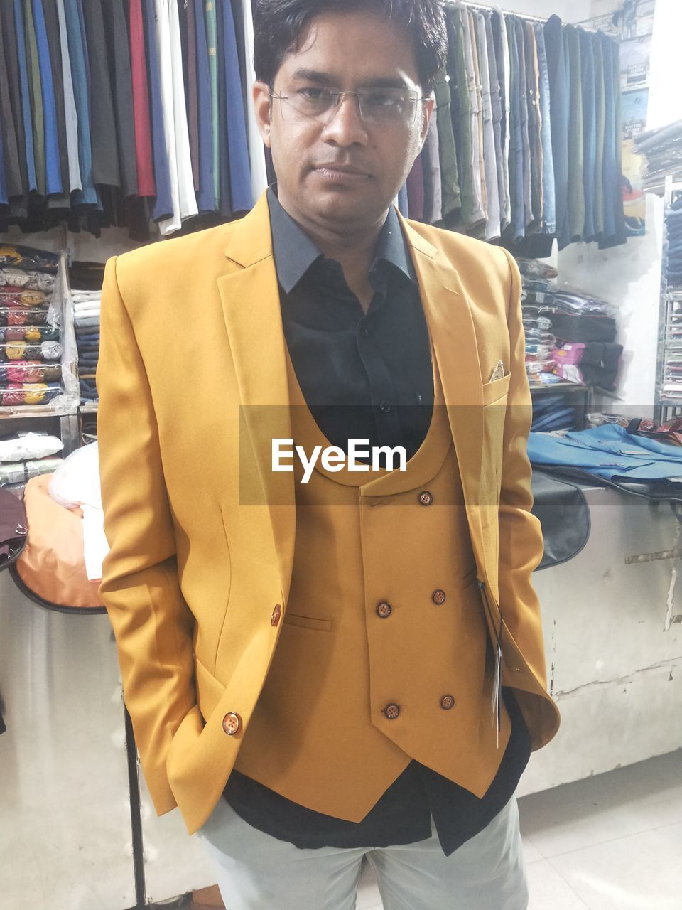 one person, adult, business, men, clothing, business finance and industry, fashion, retail, store, shopping, indoors, standing, occupation, portrait, young adult, jacket, person, front view, looking at camera, small business, looking, waist up, formal wear, consumerism, businessman, three quarter length, arts culture and entertainment, lifestyles