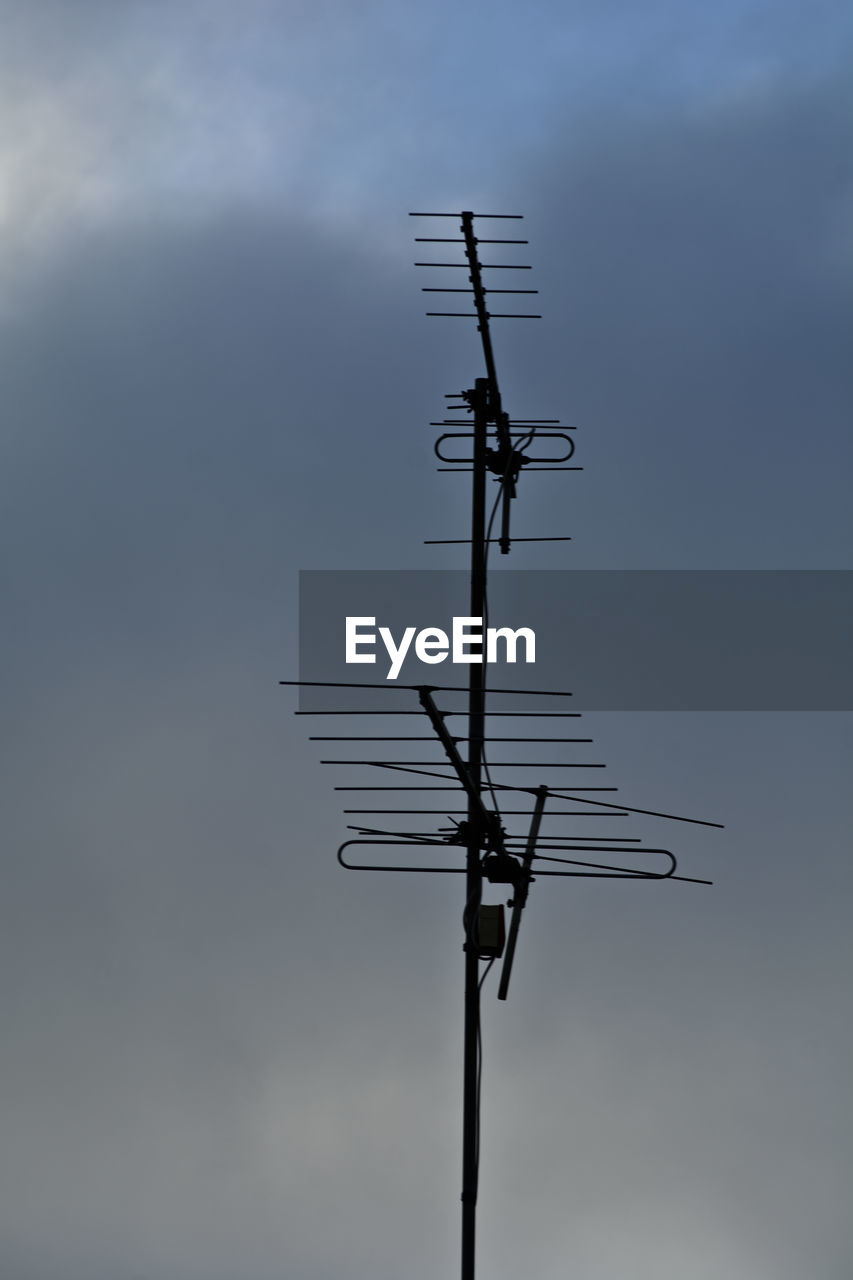 sky, technology, communication, wind, low angle view, television antenna, nature, no people, antenna, cloud, electricity, line, day, mast, telecommunications equipment, outdoors, overhead power line, machine, weather vane, electronic device, broadcasting, silhouette, television aerial