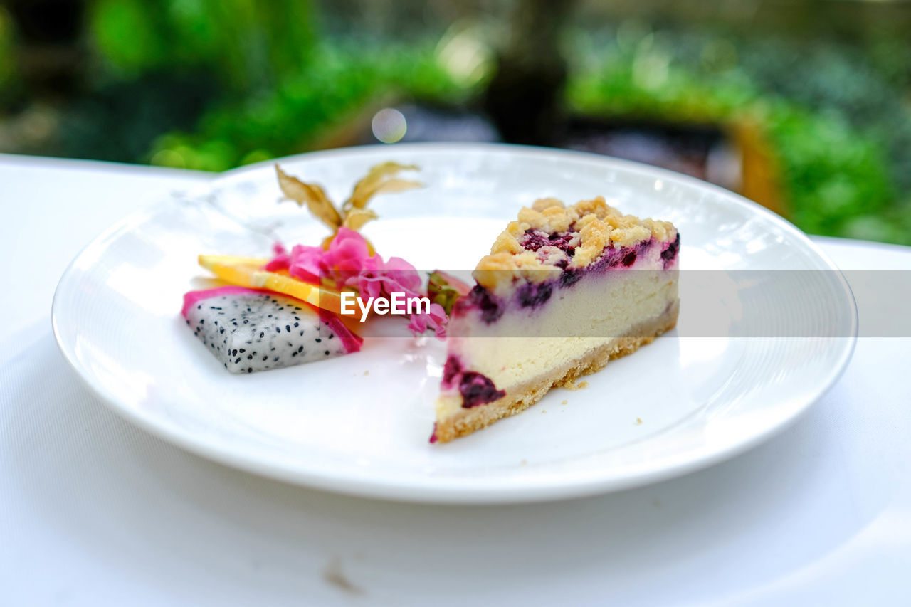 plate, food and drink, food, plant, sweet food, sweet, dessert, fruit, cake, freshness, produce, healthy eating, dish, baked, berry, cheesecake, slice, nature, no people, breakfast, meal, summer, slice of cake, temptation, table, close-up, outdoors, gourmet, focus on foreground, day, wellbeing