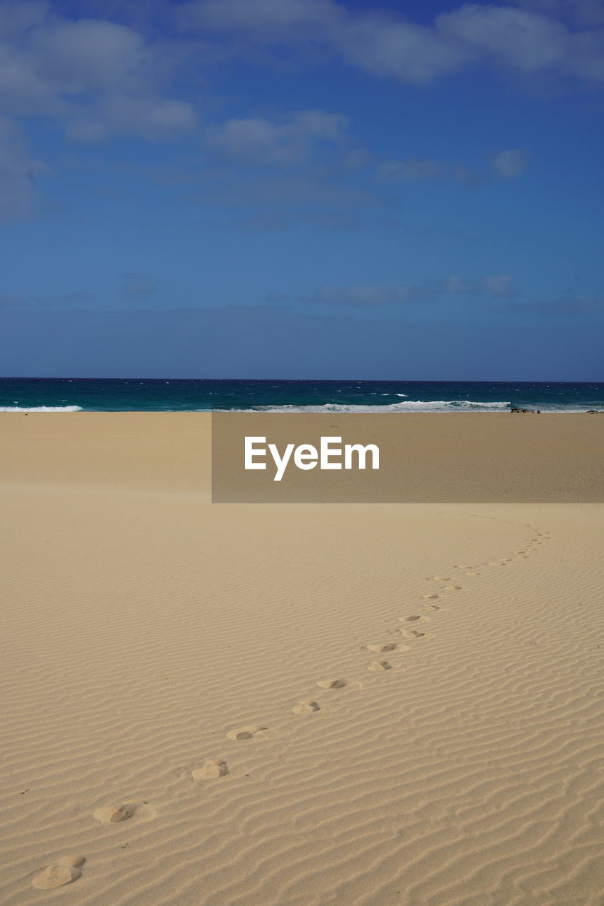 sand, blue, land, no people, nature, day, beach, pattern, outdoors, natural environment, water, sky, tranquility, beauty in nature, full frame, line, scenics - nature, backgrounds, azure, sunlight, wall