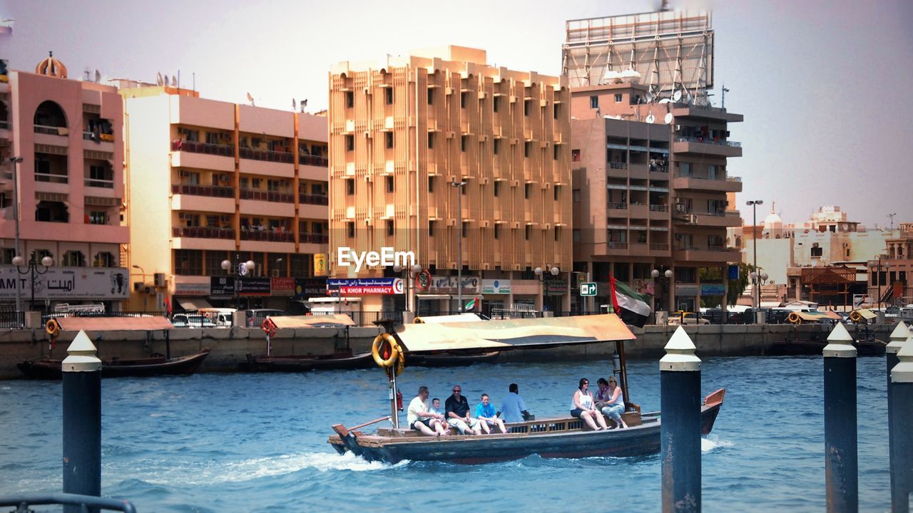 BOATS IN CITY AT WATERFRONT