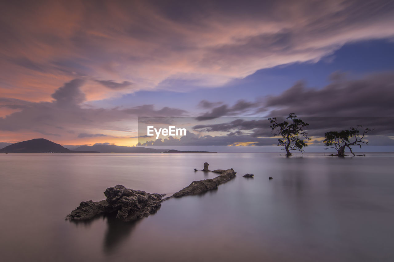 Scenic view of lake against sky during sunset