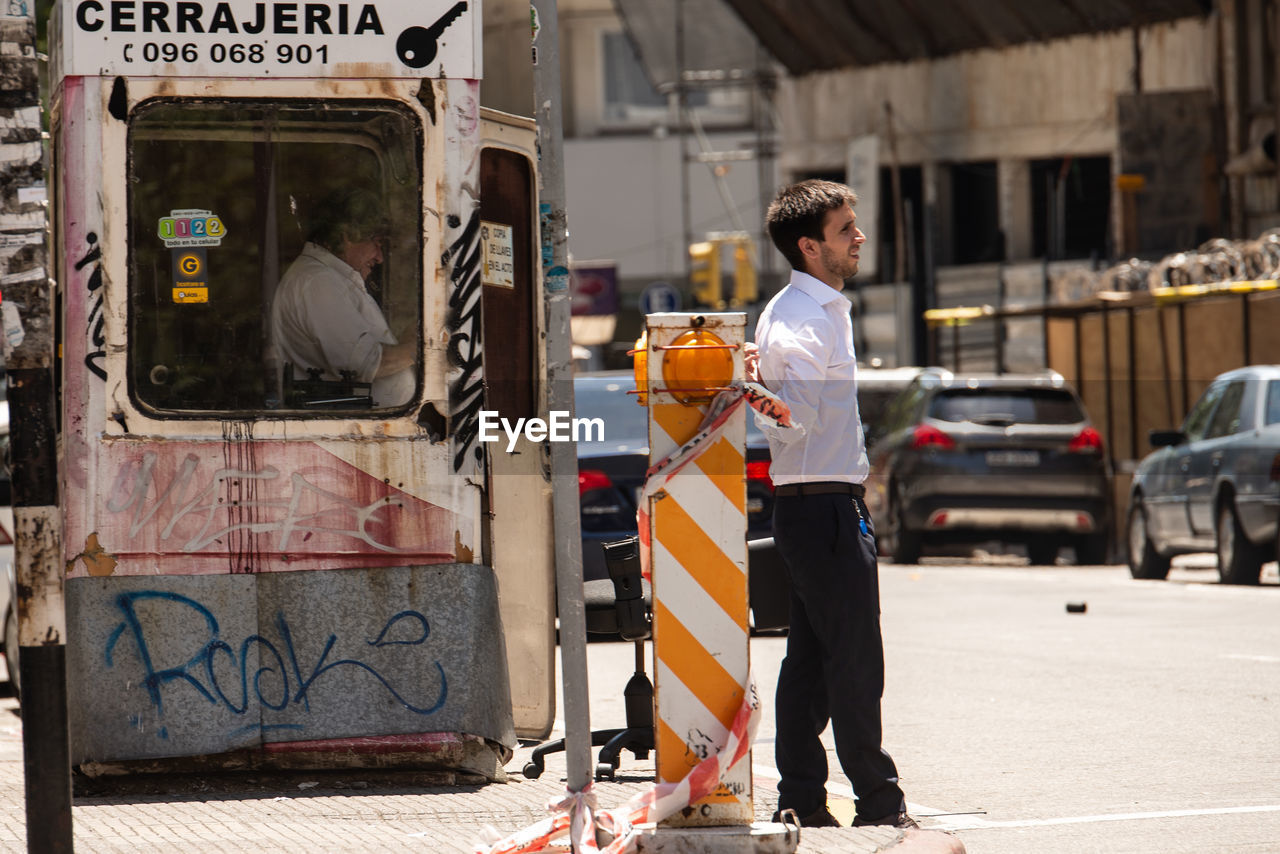 MAN STANDING ON STREET