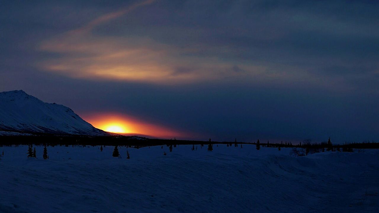 SNOW COVERED LANDSCAPE AT SUNSET