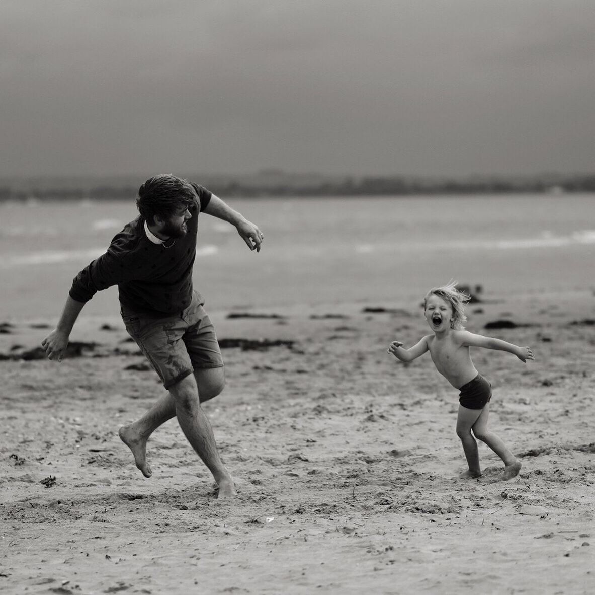 FULL LENGTH OF BOY PLAYING ON BEACH