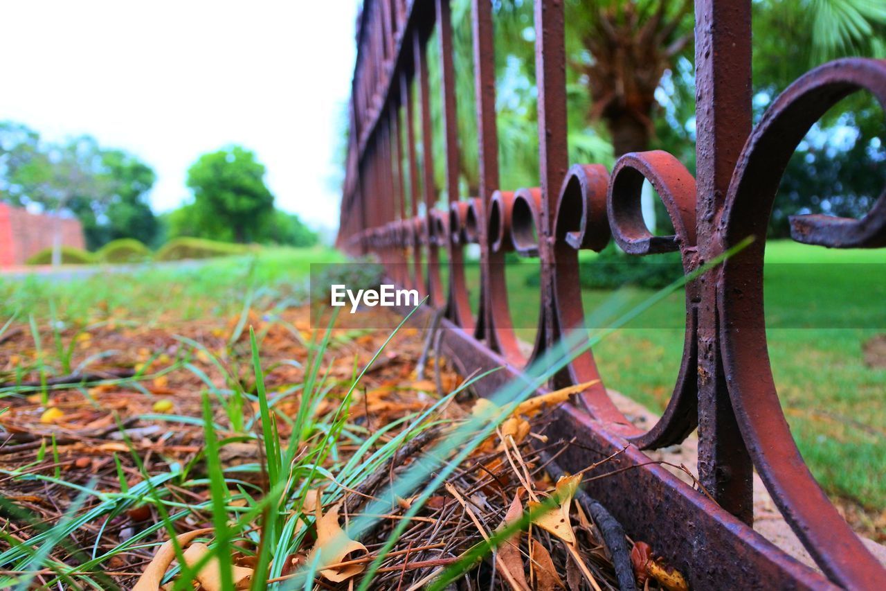 Close-up of rusty metallic structure against sky