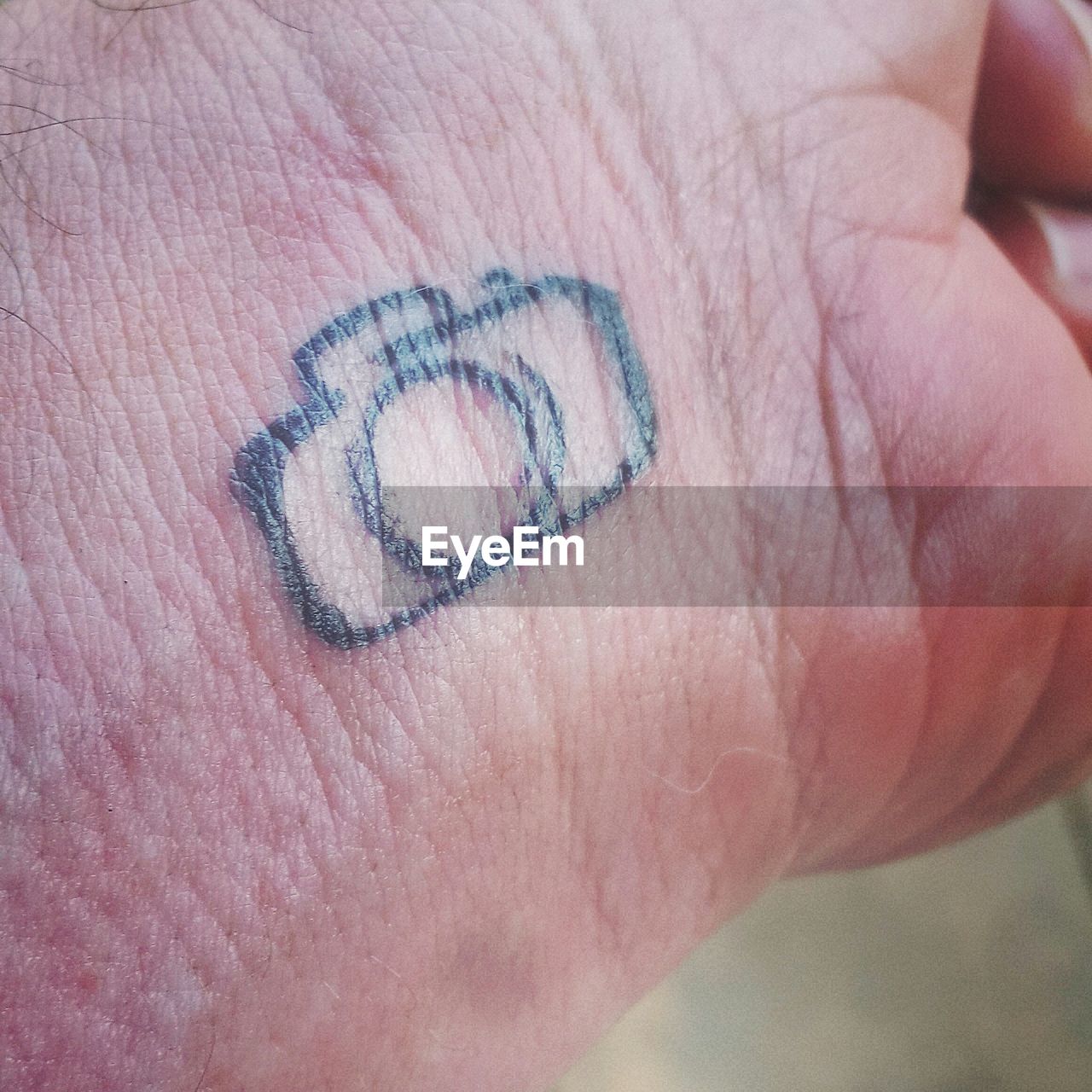 Cropped hand of person with tattoo
