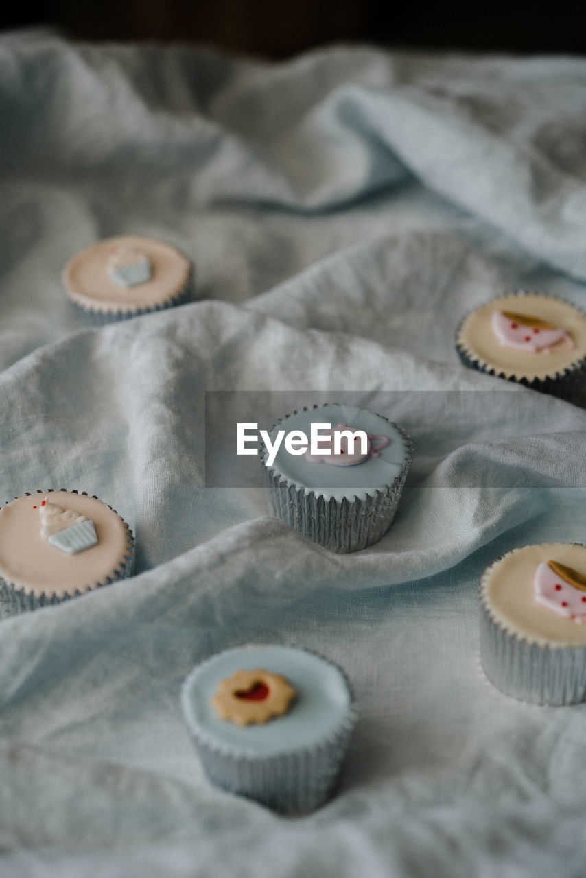 High angle view of cupcakes on fabric