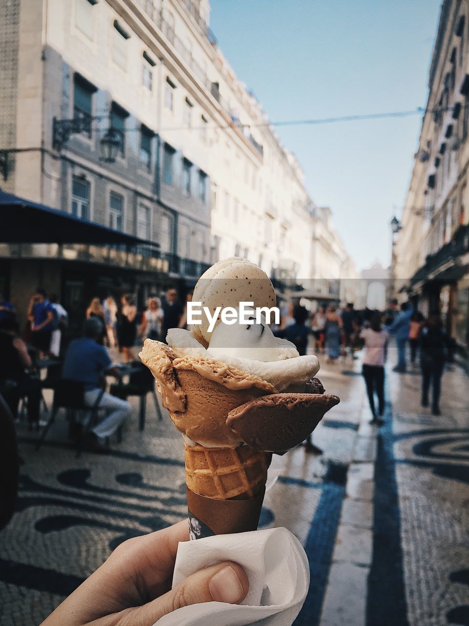People holding ice cream in city