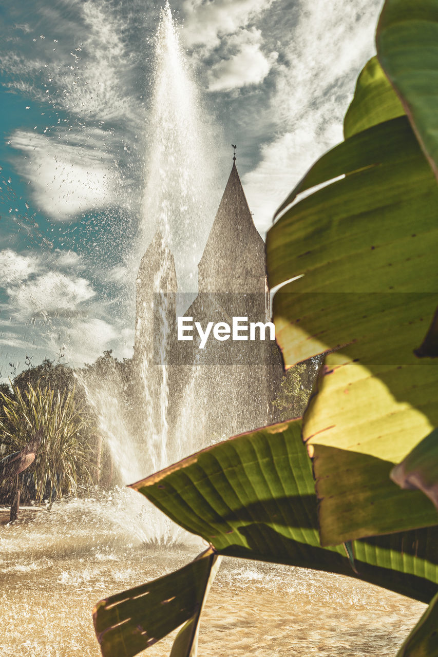 CLOSE-UP OF FOUNTAIN IN SEA AGAINST SKY