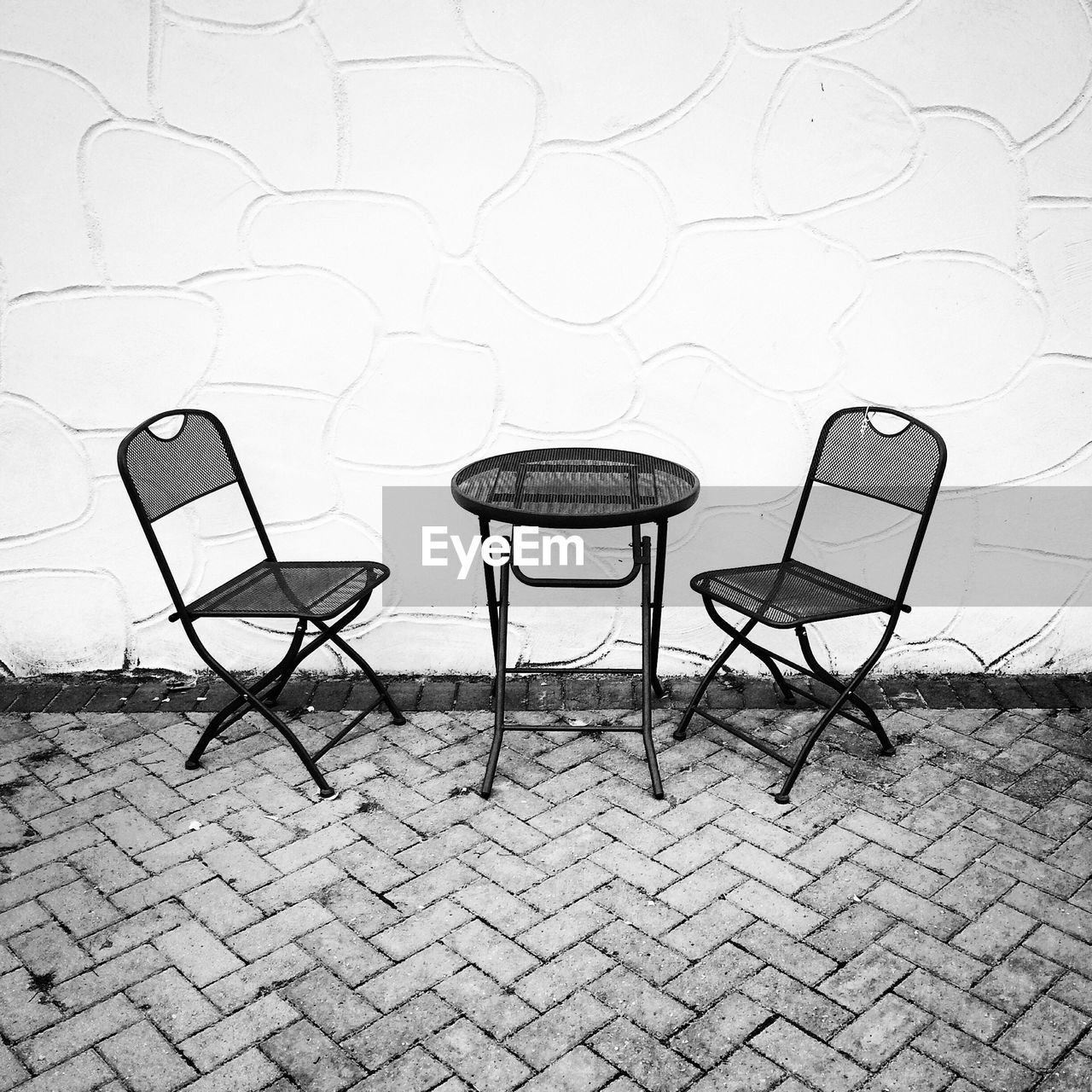 Chairs and table against the wall