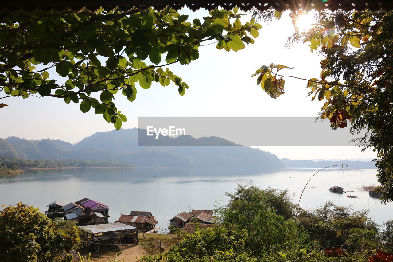 SCENIC VIEW OF LAKE BY TREE MOUNTAINS AGAINST SKY