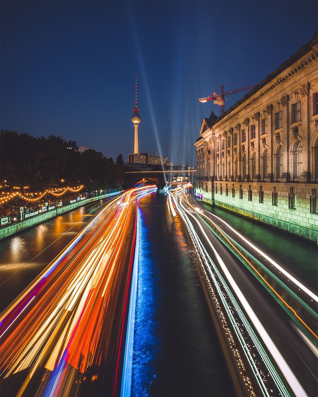 High angle view of light trails on street by bode museum against sky at night