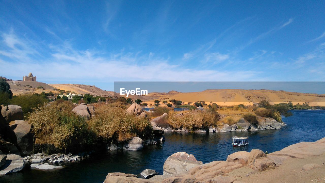 Scenic view of lake against blue sky