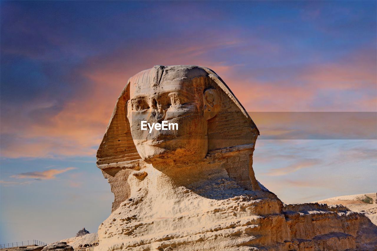 LOW ANGLE VIEW OF ROCK FORMATION AGAINST SKY