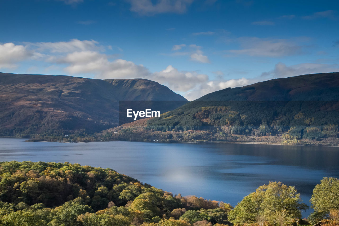 Scenic view of lake and mountains against sky