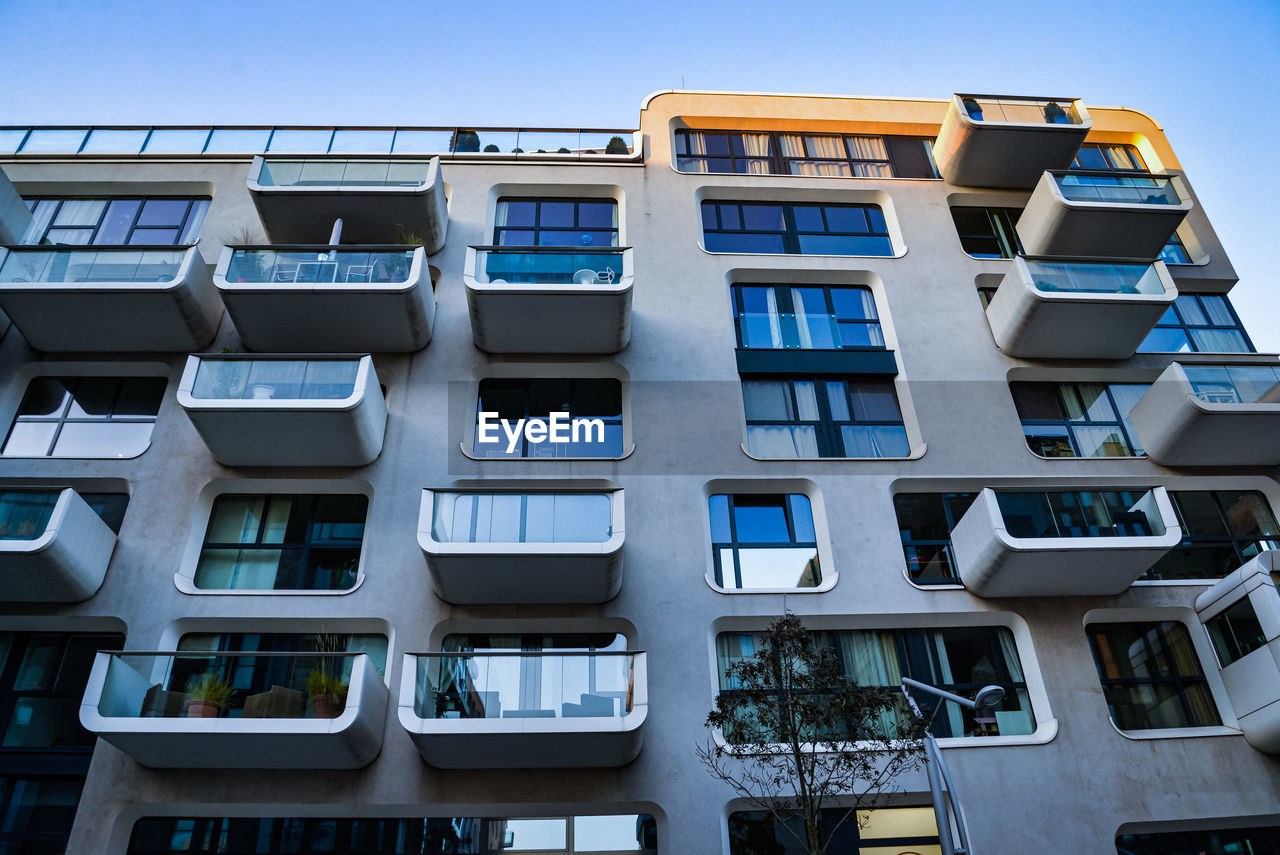 Low angle view of modern german building against clear blue sky