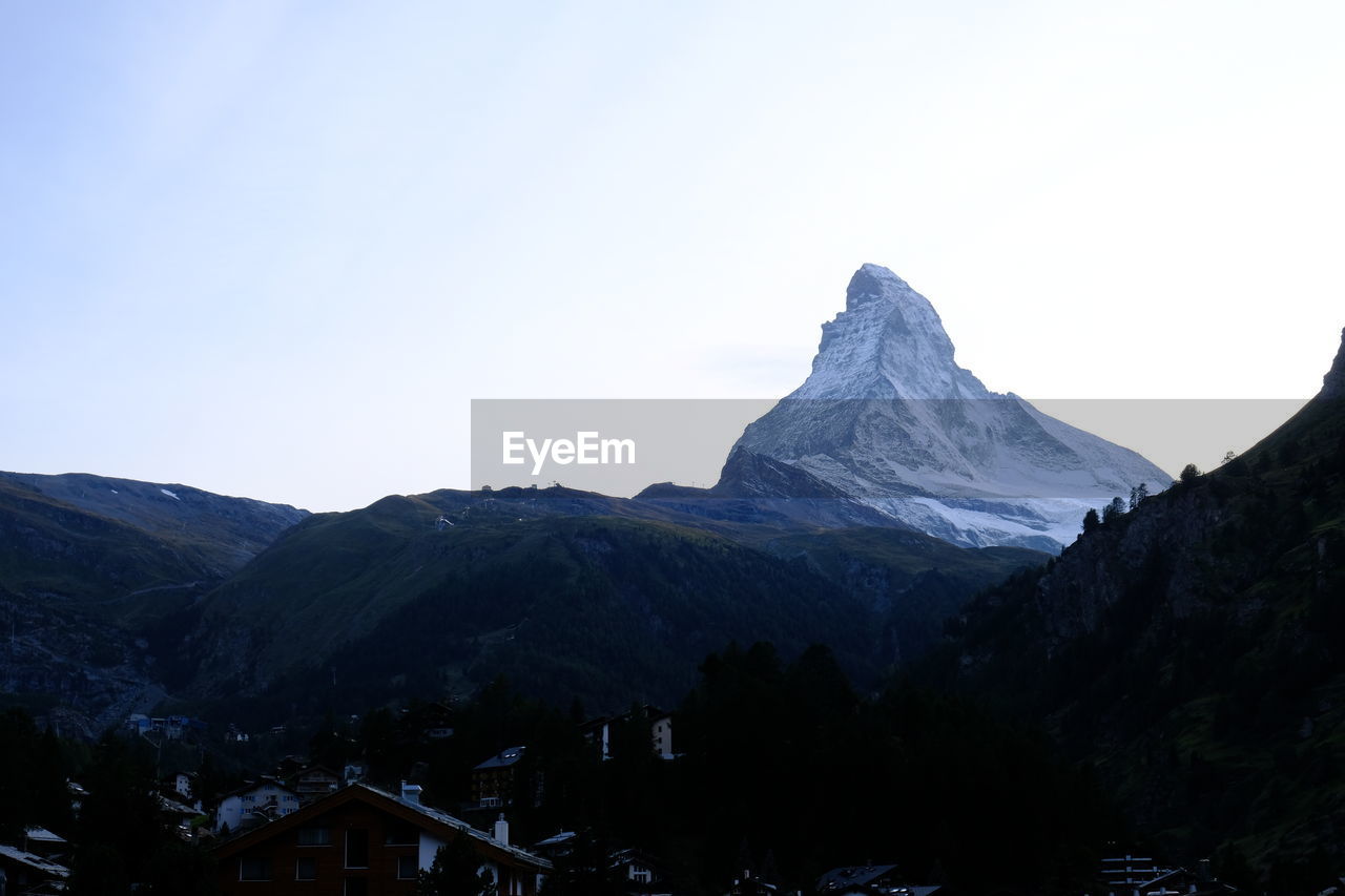 Scenic view of snowcapped mountains against clear sky