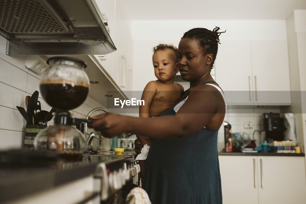 Mother with toddler in kitchen