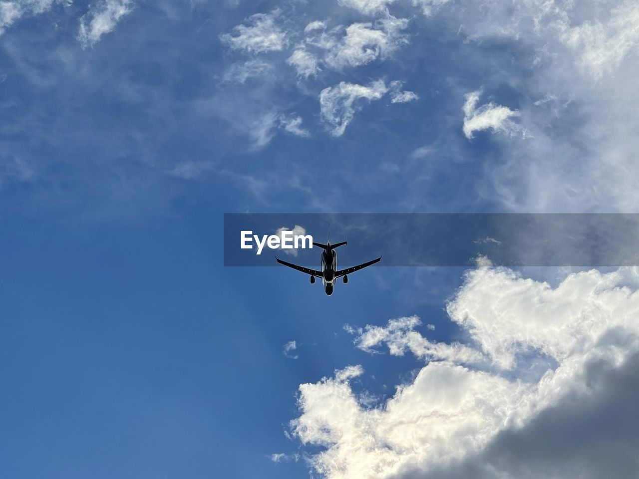 sky, flying, cloud, air vehicle, airplane, transportation, mode of transportation, nature, blue, low angle view, mid-air, travel, on the move, no people, wing, motion, day, aviation, vehicle, aircraft, outdoors, air show, air travel, plane