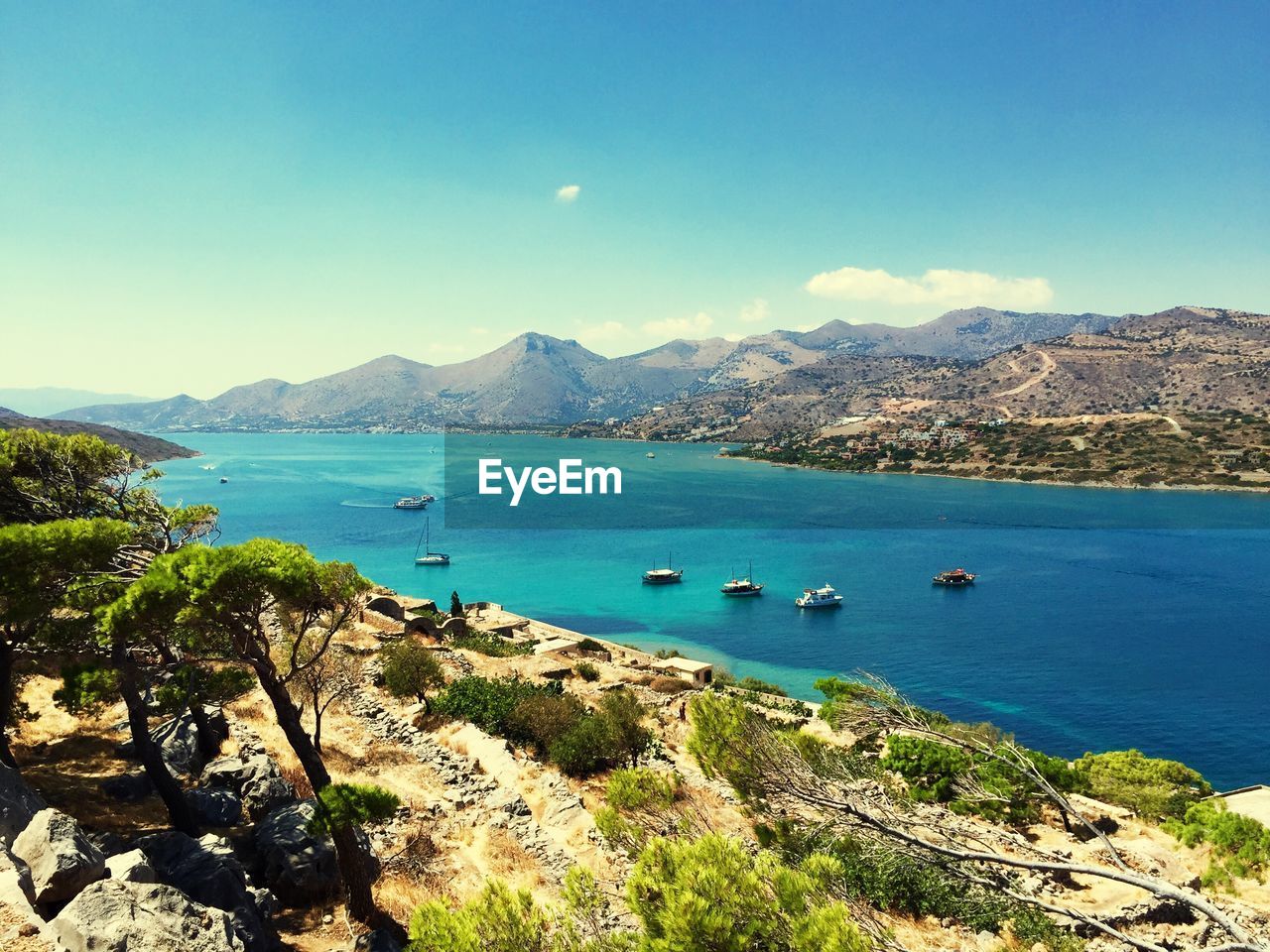 Scenic view of boats in sea against sky