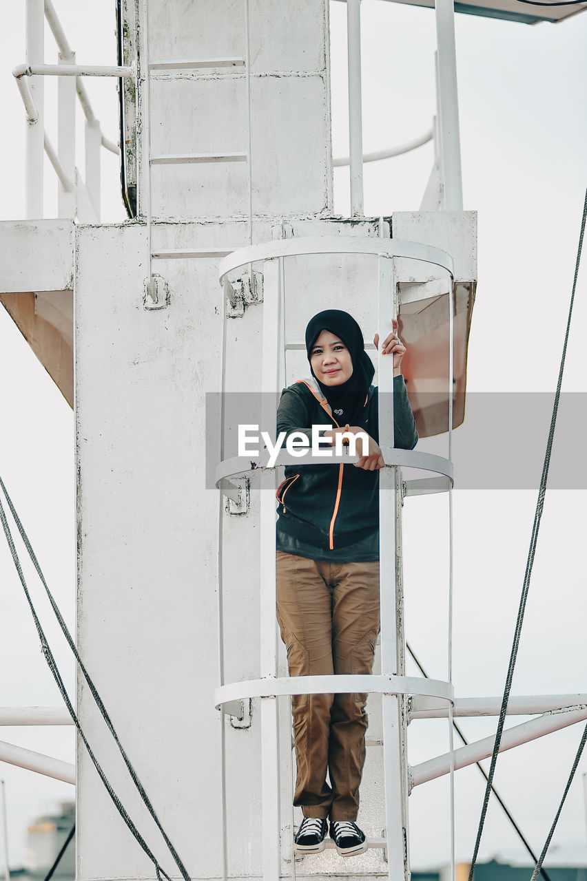 Rear view of woman standing in boat