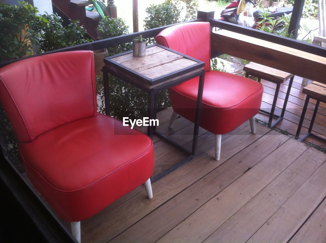 EMPTY CHAIRS AND TABLE BY RED CHAIR